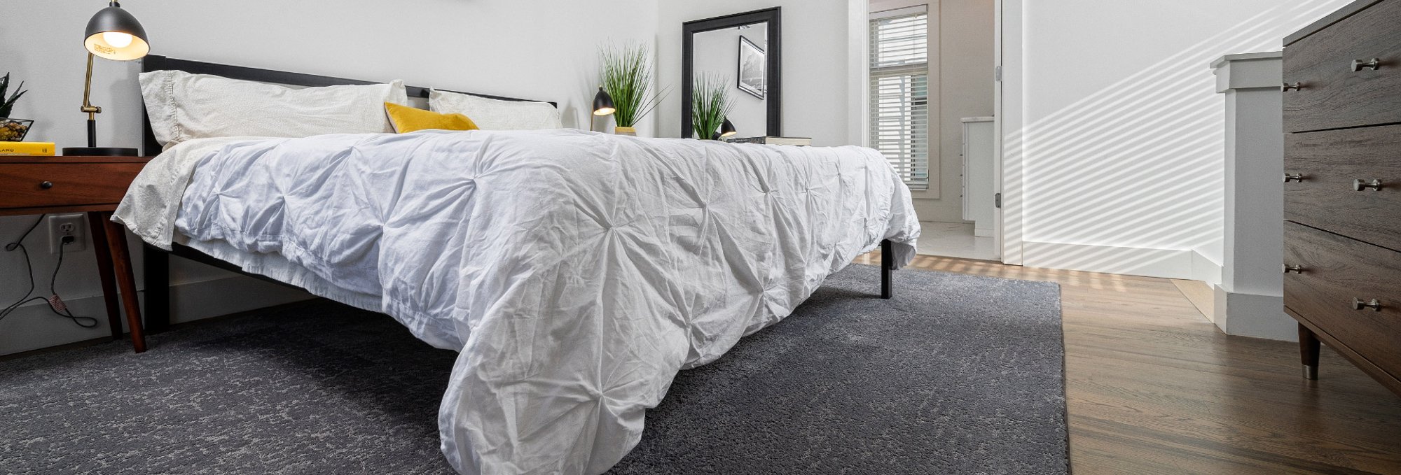 Cozy bedroom with gray carpet floor from Eastern Floor Covering in Virginia area